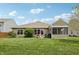 Beautiful backyard with green lawn, landscaping, and a screened in porch, perfect for relaxation at 8855 Banner Dr, Brownsburg, IN 46112