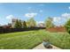 Expansive backyard featuring lush lawn, privacy fence, and landscaped details at 8855 Banner Dr, Brownsburg, IN 46112