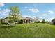 Large backyard with manicured lawn and mature trees, perfect for outdoor activities at 8855 Banner Dr, Brownsburg, IN 46112
