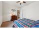 Inviting bedroom with a ceiling fan, a dresser with a round mirror, and neutral carpet for a cozy feel at 8855 Banner Dr, Brownsburg, IN 46112