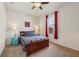 Cozy bedroom with natural light, a ceiling fan, and a comfortable bed adorned with patterned bedding at 8855 Banner Dr, Brownsburg, IN 46112