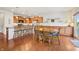 Eat-in kitchen with hardwood floors, wooden table, and many chairs at 8855 Banner Dr, Brownsburg, IN 46112