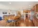 Open concept living area with a spacious dining table, seating eight, and a modern kitchen with stainless steel appliances at 8855 Banner Dr, Brownsburg, IN 46112
