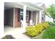 Cozy front porch with comfortable seating, stylish shutters, and meticulously maintained landscaping at 8855 Banner Dr, Brownsburg, IN 46112