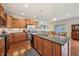 Bright kitchen with wood cabinets, stainless appliances, granite counters, and a spacious island for seating at 8855 Banner Dr, Brownsburg, IN 46112