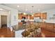 Spacious kitchen featuring stainless appliances, a large island with seating, and warm wood cabinets at 8855 Banner Dr, Brownsburg, IN 46112