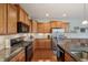 Modern kitchen with stainless steel appliances, granite countertops, and ample cabinetry at 8855 Banner Dr, Brownsburg, IN 46112