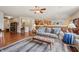 Open-concept living room with hardwood floors flowing into the kitchen and dining area at 8855 Banner Dr, Brownsburg, IN 46112