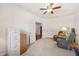 Bright living room with neutral carpet, ceiling fan, and white walls showcasing a comfortable seating area at 8855 Banner Dr, Brownsburg, IN 46112