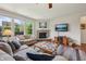 Cozy living room with a stone fireplace, plush seating, and ample natural light at 8855 Banner Dr, Brownsburg, IN 46112