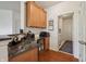 Functional office nook with granite countertops and ample cabinet space, adjoining the kitchen and laundry at 8855 Banner Dr, Brownsburg, IN 46112