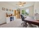 Bright office space with a ceiling fan, a large window, and organized shelving for a productive work environment at 8855 Banner Dr, Brownsburg, IN 46112