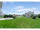 Expansive backyard with lush green grass, mature trees, and beautifully landscaped areas at 996 Denton Ct, Westfield, IN 46074