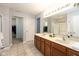 A full bathroom boasts dual sinks, a shower, neutral paint, and views into the closet at 996 Denton Ct, Westfield, IN 46074