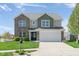 Charming two-story home with manicured lawn, brick and siding accents, and attached two-car garage at 996 Denton Ct, Westfield, IN 46074
