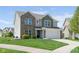 Charming two-story home with a manicured lawn and an attached two-car garage at 996 Denton Ct, Westfield, IN 46074