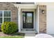 Inviting front door with hanging plants, decorative accents, and well-maintained landscaping at 996 Denton Ct, Westfield, IN 46074