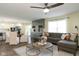 Open-concept living room with neutral decor, modern furnishings, hardwood floors, and seamless kitchen access at 996 Denton Ct, Westfield, IN 46074