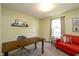 A comfortable office with a large desk, sofa, and natural light from the window at 996 Denton Ct, Westfield, IN 46074