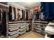 Walk-in closet with white storage drawers and multiple shelves for clothing and shoes at 996 Denton Ct, Westfield, IN 46074