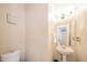 This bathroom includes a white toilet, sink and mirror with decorative accents at 10090 Eagle Eye Way, Indianapolis, IN 46234