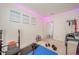 Home gym boasts a treadmill, weight bench, free weights, rubber flooring, a full length mirror, and LED lighting at 10090 Eagle Eye Way, Indianapolis, IN 46234