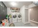Organized laundry room with washer, dryer, shelving, and stylish patterned flooring at 10090 Eagle Eye Way, Indianapolis, IN 46234