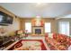 Cozy living room featuring a stone fireplace, floral sofa, and a TV for entertainment at 10090 Eagle Eye Way, Indianapolis, IN 46234