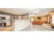 Open-concept living space with a kitchen, Gathering room, and bar seating for casual dining at 10090 Eagle Eye Way, Indianapolis, IN 46234