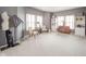 A large sitting room is brightly lit with two large windows and has a table with chairs and shelving at 10090 Eagle Eye Way, Indianapolis, IN 46234