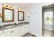 Bright bathroom boasts double vanity with white cabinetry and elegant gold-framed mirrors at 10524 Hawks Ridge Ct, Fishers, IN 46037