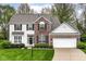 Charming two-story home featuring a brick and white siding facade and a well-manicured front yard at 10524 Hawks Ridge Ct, Fishers, IN 46037