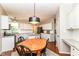 Eat-in kitchen features granite counters, white cabinets, stainless appliances, and an adjacent dining area at 10524 Hawks Ridge Ct, Fishers, IN 46037