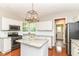 Bright kitchen with white cabinets, granite countertops, stainless steel appliances, and a center island at 10524 Hawks Ridge Ct, Fishers, IN 46037