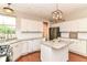 A well-lit kitchen featuring granite countertops, white cabinetry, stainless steel appliances, and a functional island at 10524 Hawks Ridge Ct, Fishers, IN 46037