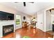 Inviting living room featuring hardwood floors, a cozy fireplace, and a seamless transition to the kitchen at 10524 Hawks Ridge Ct, Fishers, IN 46037