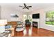 Cozy living room with hardwood floors, fireplace, large windows, and comfortable seating arrangement at 10524 Hawks Ridge Ct, Fishers, IN 46037