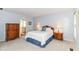 This main bedroom features a serene atmosphere, complemented by neutral paint and classic wooden furniture at 10524 Hawks Ridge Ct, Fishers, IN 46037