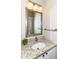 Stylish powder room featuring a granite countertop, modern fixtures, and decorative mirror, adding elegance and convenience at 10524 Hawks Ridge Ct, Fishers, IN 46037