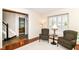 Sitting room with comfortable seating next to a stairway leading up and a glimpse of the dining room, perfect for guests at 10524 Hawks Ridge Ct, Fishers, IN 46037