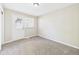 This carpeted bedroom offers an exterior door and a window for natural light at 108 W Cross St, Anderson, IN 46012
