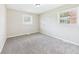 Bright bedroom with neutral paint, cozy carpet, and natural light from the two windows at 108 W Cross St, Anderson, IN 46012