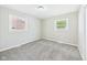 This bedroom features two windows, soft carpet, and neutral paint at 108 W Cross St, Anderson, IN 46012