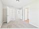 Neutral-toned bedroom has carpet flooring and several doorways to other rooms and closet spaces at 108 W Cross St, Anderson, IN 46012