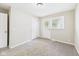 A carpeted bedroom features an exterior door with a window and a closet at 108 W Cross St, Anderson, IN 46012