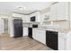 Bright kitchen with modern appliances, countertops, and white cabinets, complemented by new flooring at 108 W Cross St, Anderson, IN 46012