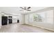Open layout reveals the kitchen with black appliances and bright white cabinets, enhanced by modern flooring at 108 W Cross St, Anderson, IN 46012