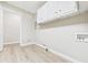 Laundry room features upper cabinets, beadboard paneling, and washer/dryer hookups at 108 W Cross St, Anderson, IN 46012