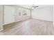 Bright living room featuring new floors, fresh paint, a large window for natural light and a ceiling fan at 108 W Cross St, Anderson, IN 46012