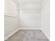 Walk-in closet has neutral-toned carpet, white wire shelves, and a window at 108 W Cross St, Anderson, IN 46012
